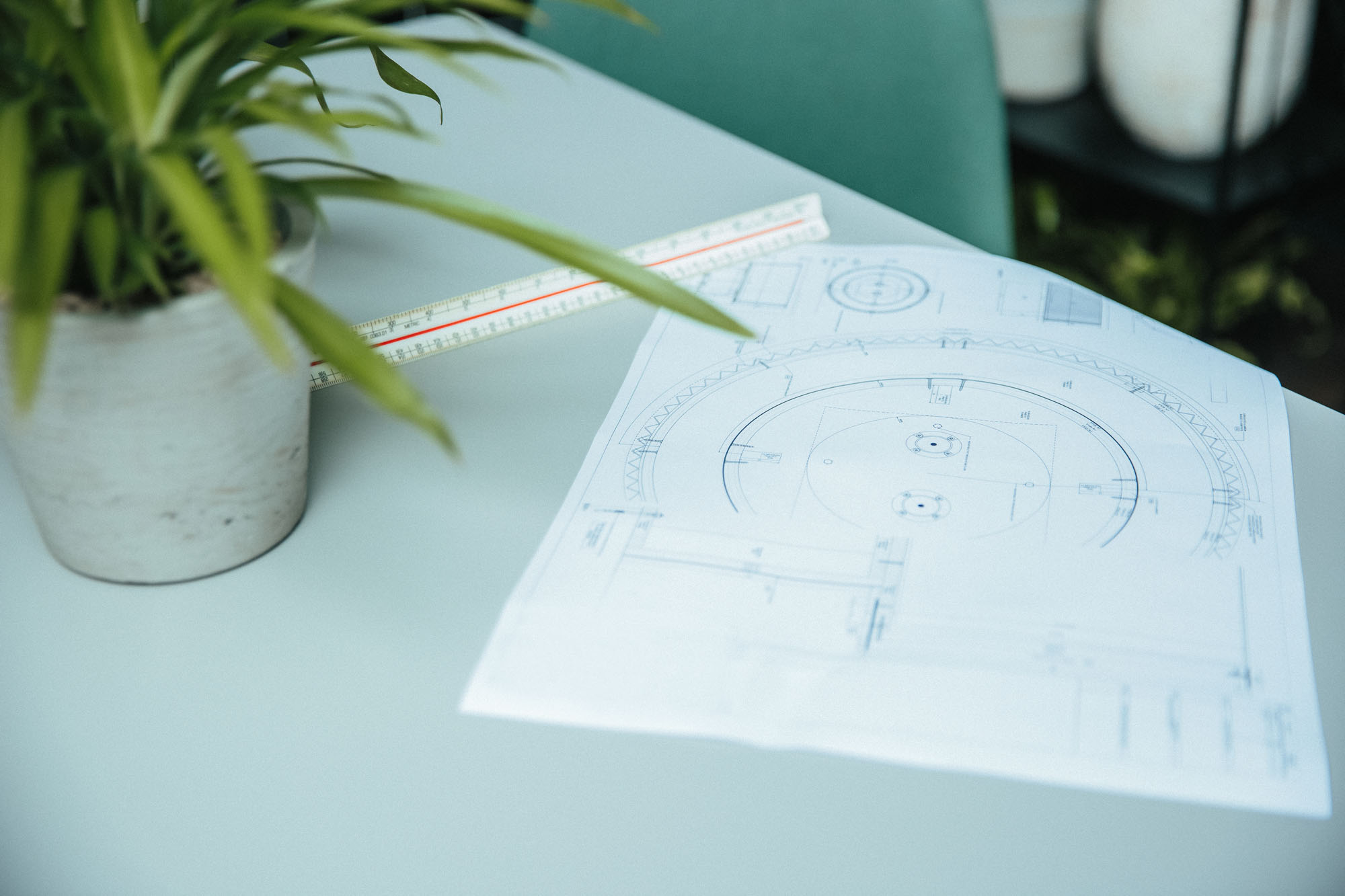 architecture sketches on table with plant and ruler