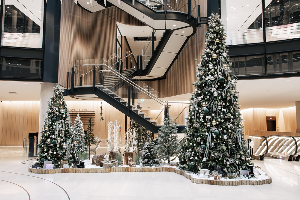 A large natural Christmas tree scene in office reception