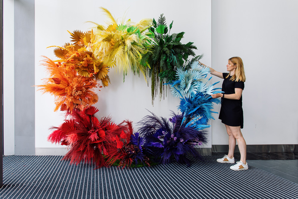 A rainbow ring of dried foliage with person standing to side