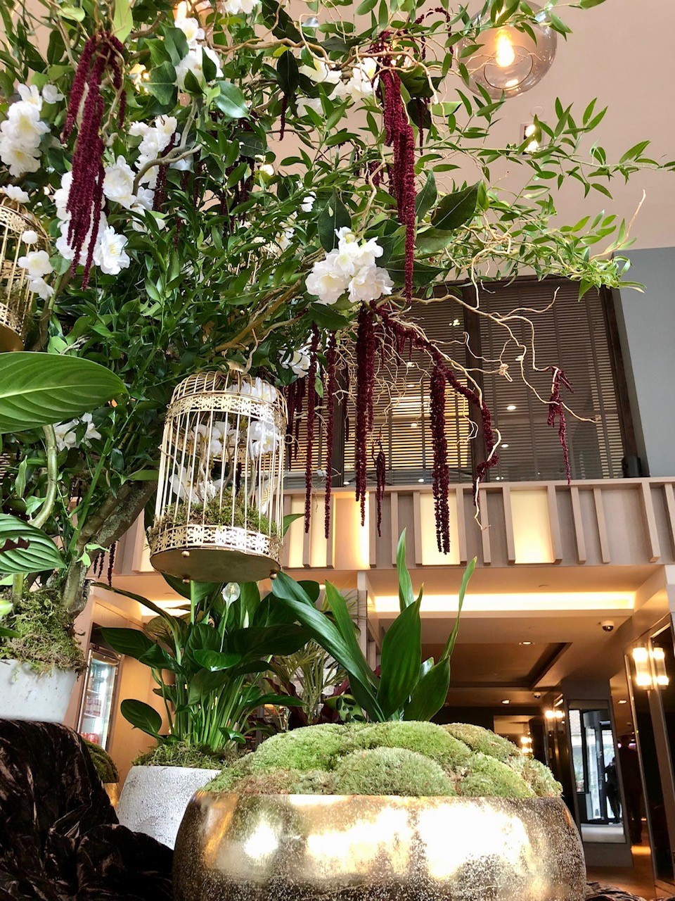 A plant install in a hotel reception with foliage and moss